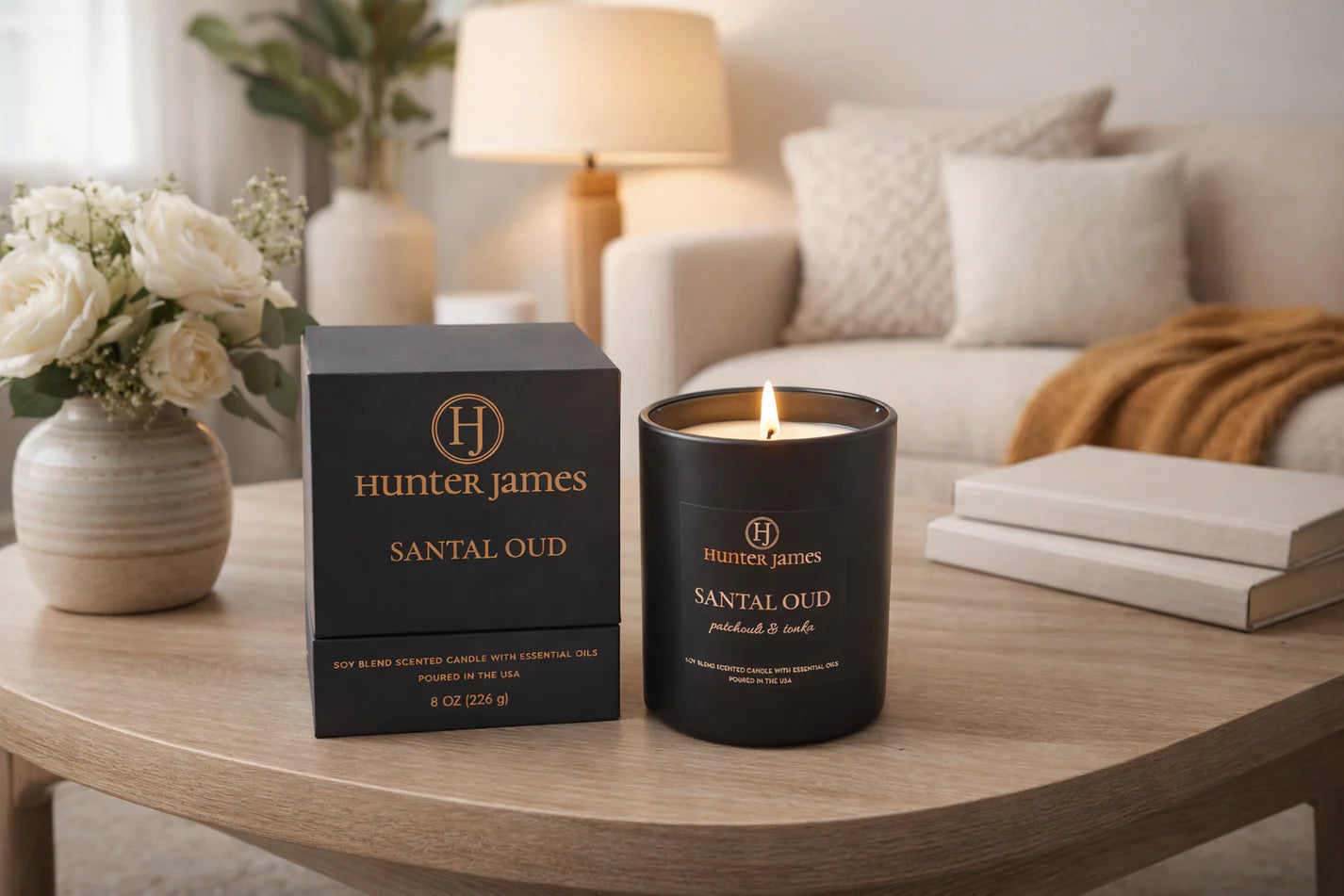 Hunter James Santal Oud candle and packaging on a wooden table in a cozy living room.