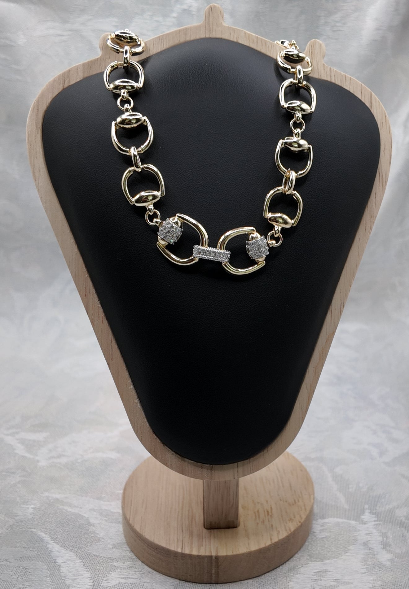 Adelaide gold horse bit necklace on black jewelry display