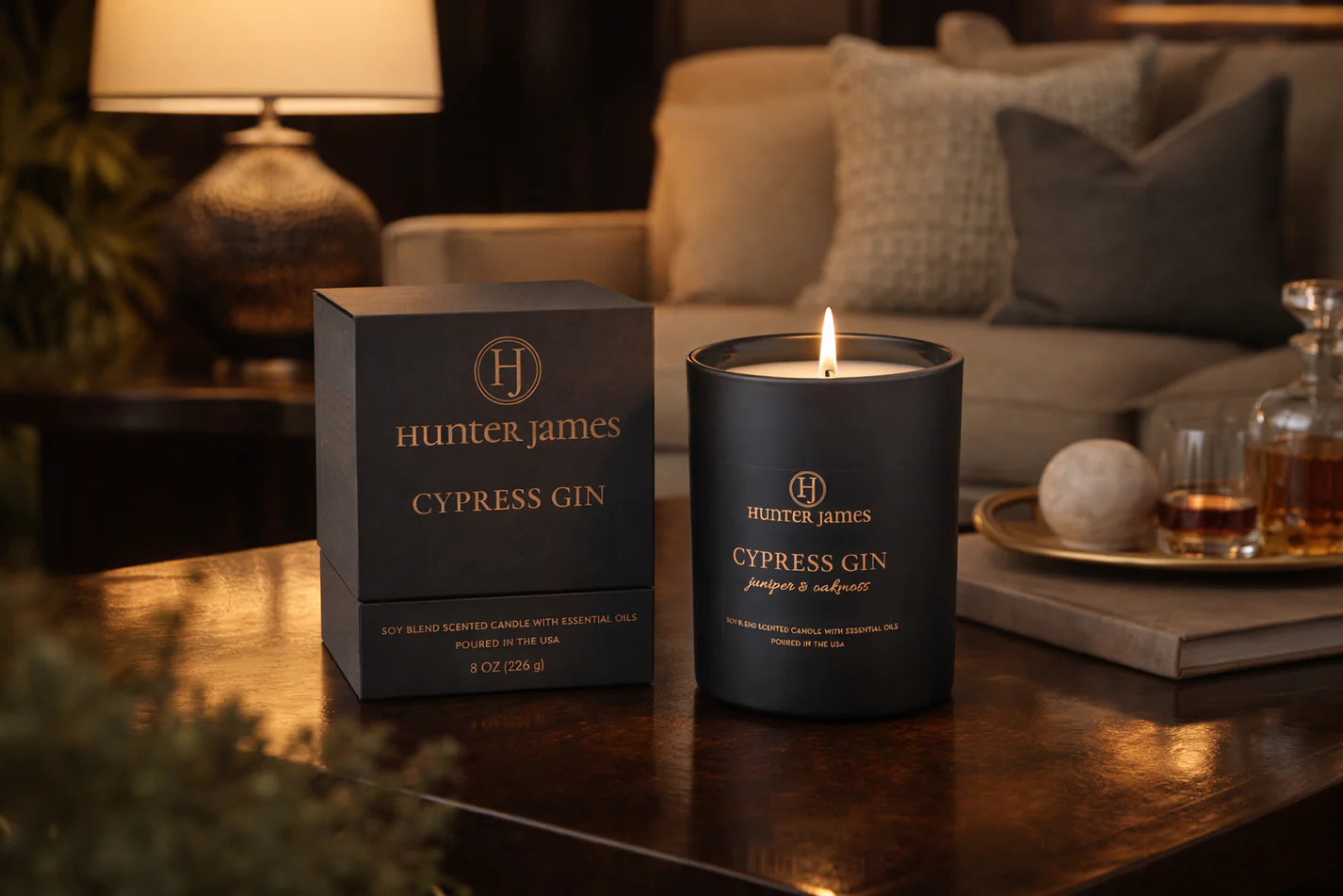 Hunter James Cypress Gin candle and packaging on a table in a cozy room.
