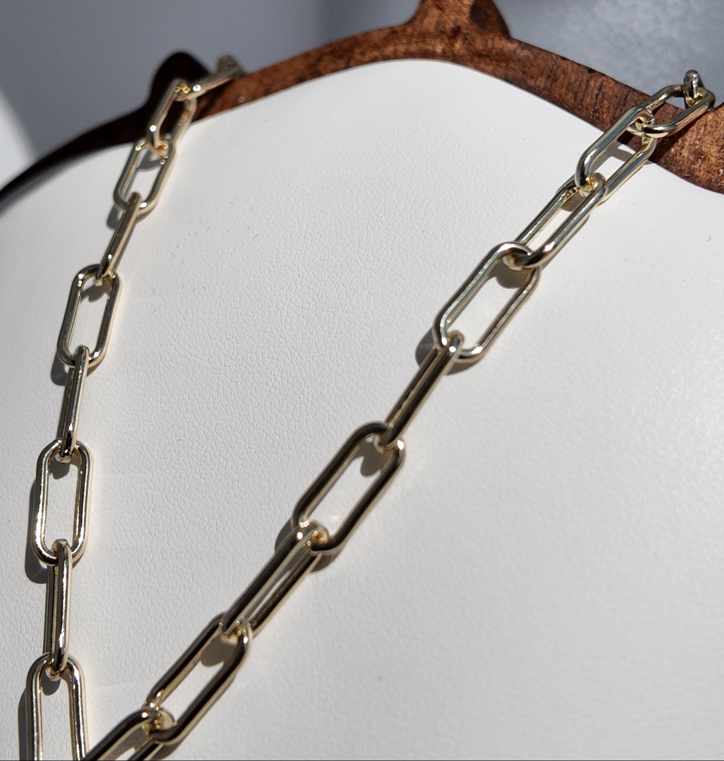 Detailed view of elongated gold chain links on Marisol Sunburst Medallion Necklace