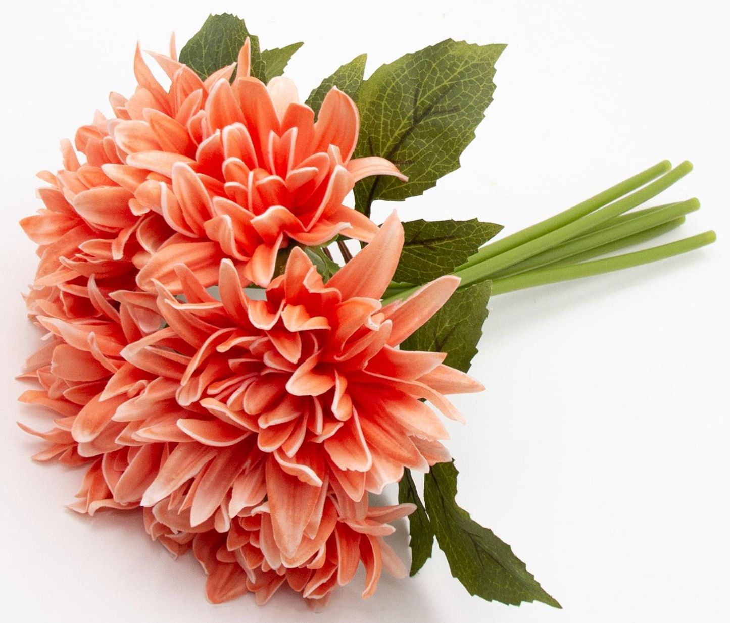 Bouquet of peach-colored real touch dahlia flowers with green leaves on a white background