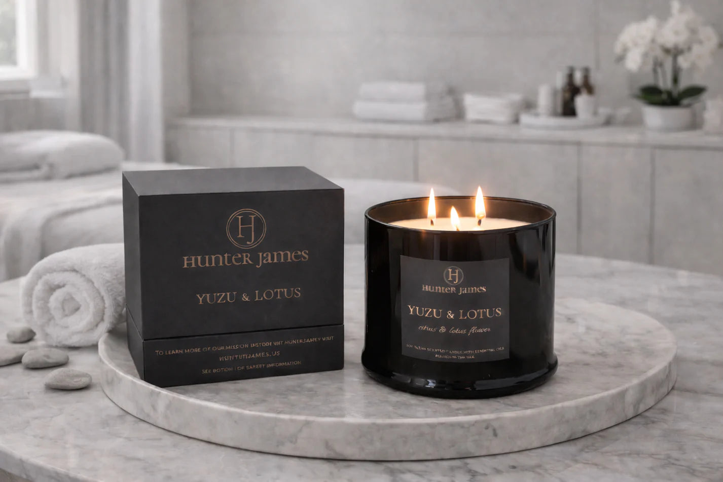 Hunter James candle and packaging on a marble surface with a bathroom background
