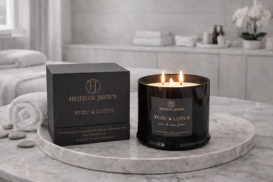 Hunter James candle and packaging on a marble surface with a bathroom background