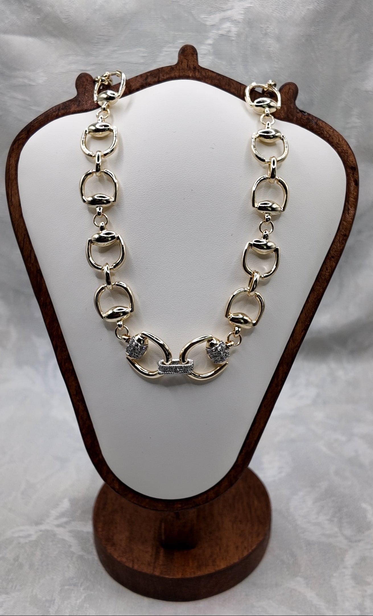 Adelaide horse bit necklace in gold on white jewelry display