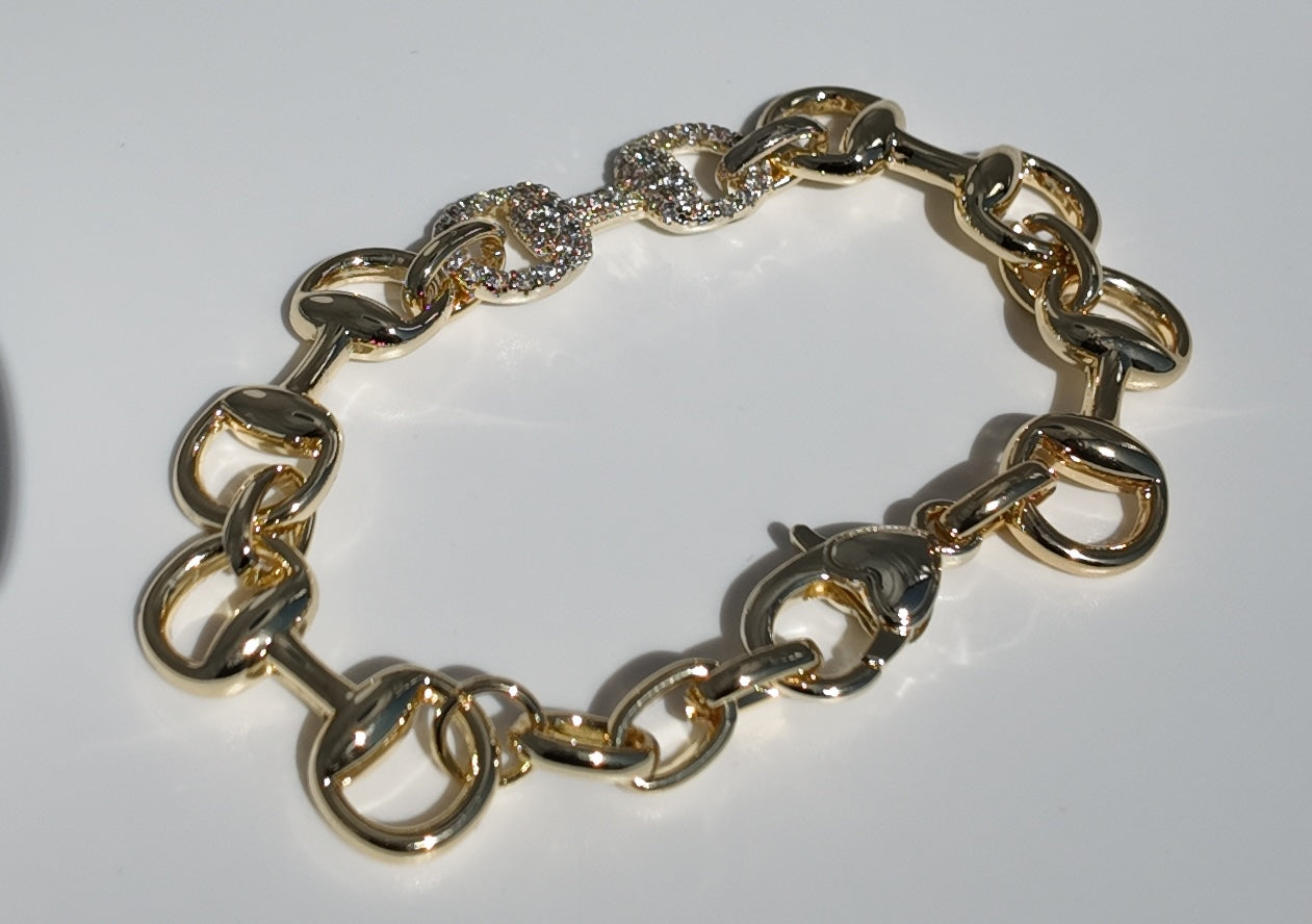     Angled product photo of Adelaide gold horsebit bracelet with crystal accents