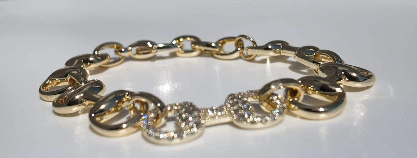     Flat lay of Adelaide gold horsebit link bracelet with pavé detailing