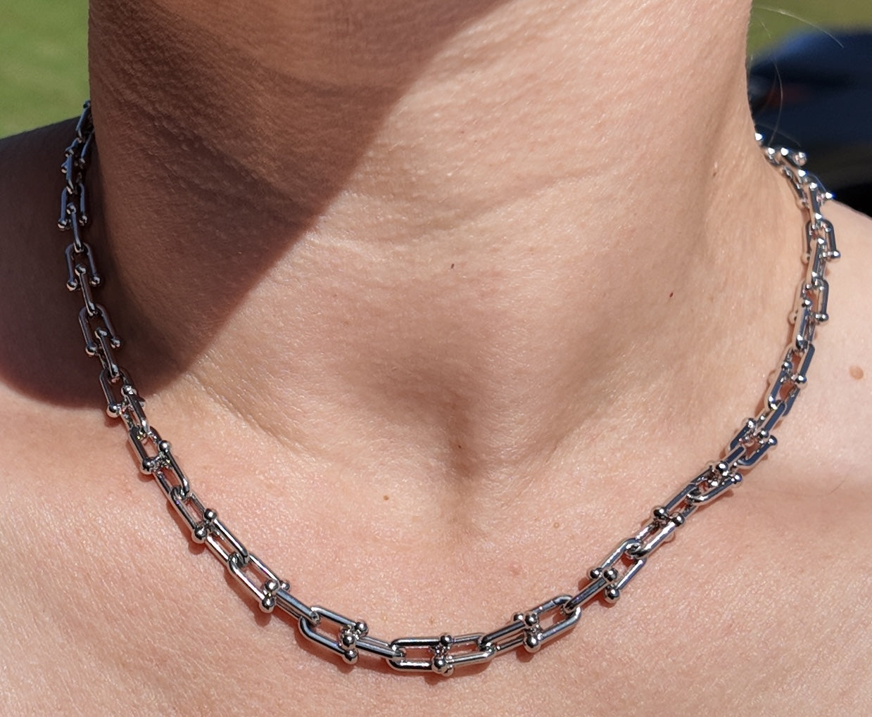 Model wearing the silver Blaire paperclip chain necklace with sleek modern styling
