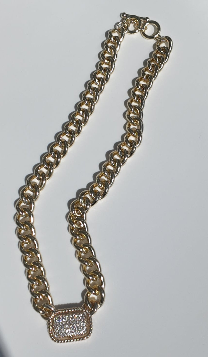 Flat lay of the Colette Pavé Link Necklace showcasing polished gold chain and pavé pendant detail