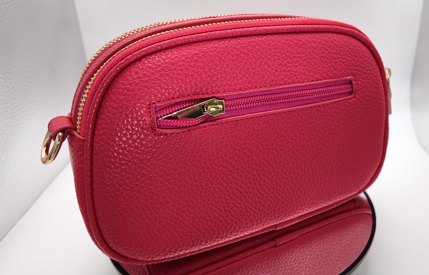 Back view of The Elodie Pebble Crossbody in Wild Rose featuring a smooth pebbled finish.