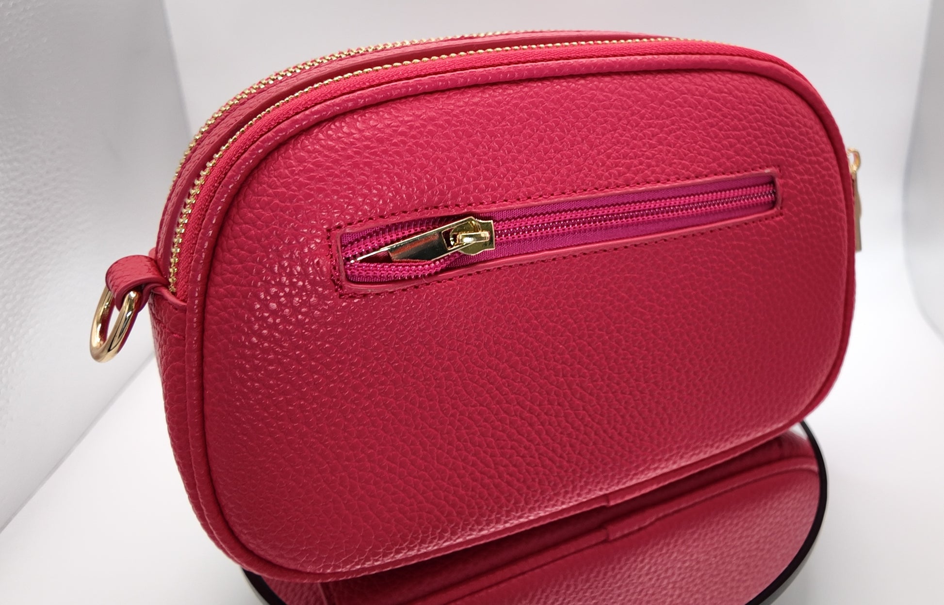 Back view of The Elodie Pebble Crossbody in Wild Rose featuring a smooth pebbled finish.