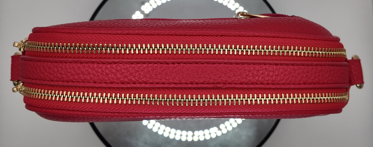 Top profile of The Elodie Pebble Crossbody in Wild Rose with gold-tone zipper detail.