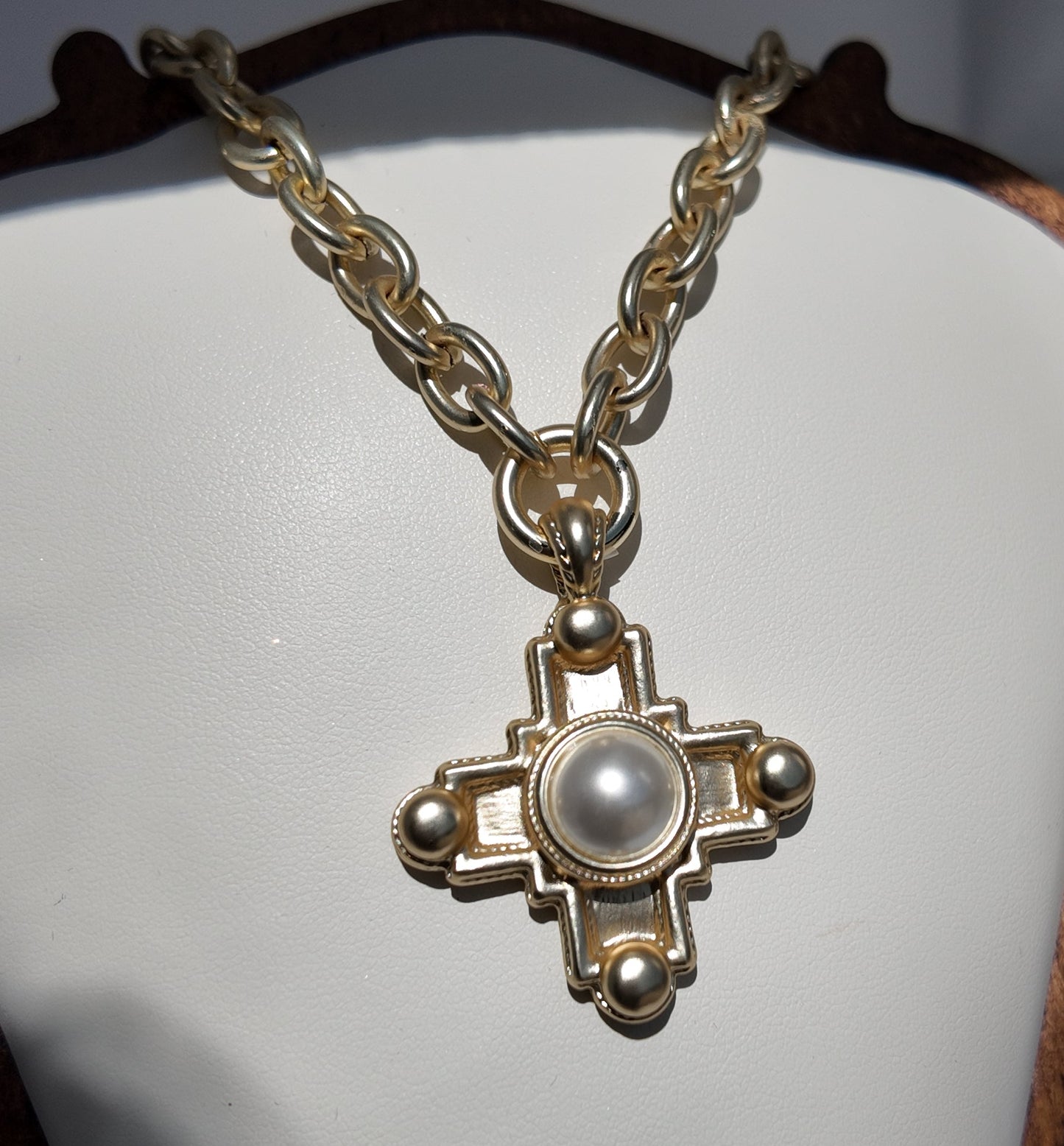 Close-up detail of pearl center cross pendant on the Evangeline Necklace