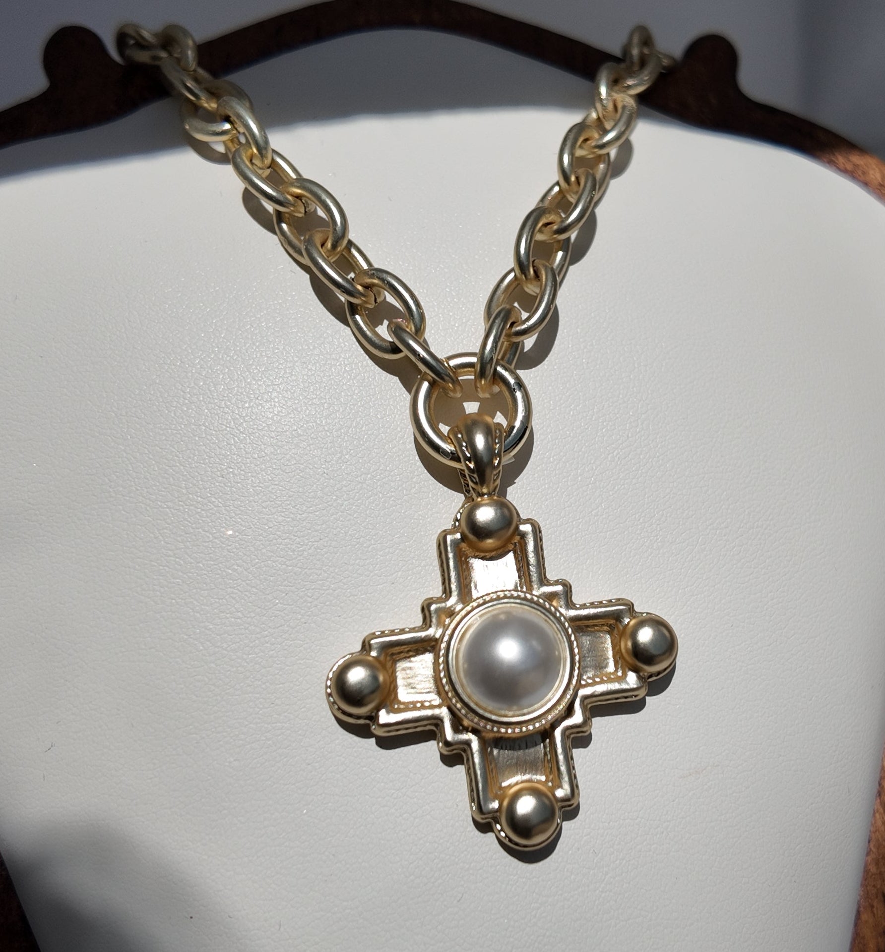 Close-up detail of pearl center cross pendant on the Evangeline Necklace