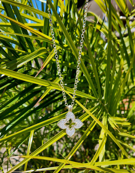 Juliette Open Motif Necklace photographed against tropical palm leaves in natural sunlight