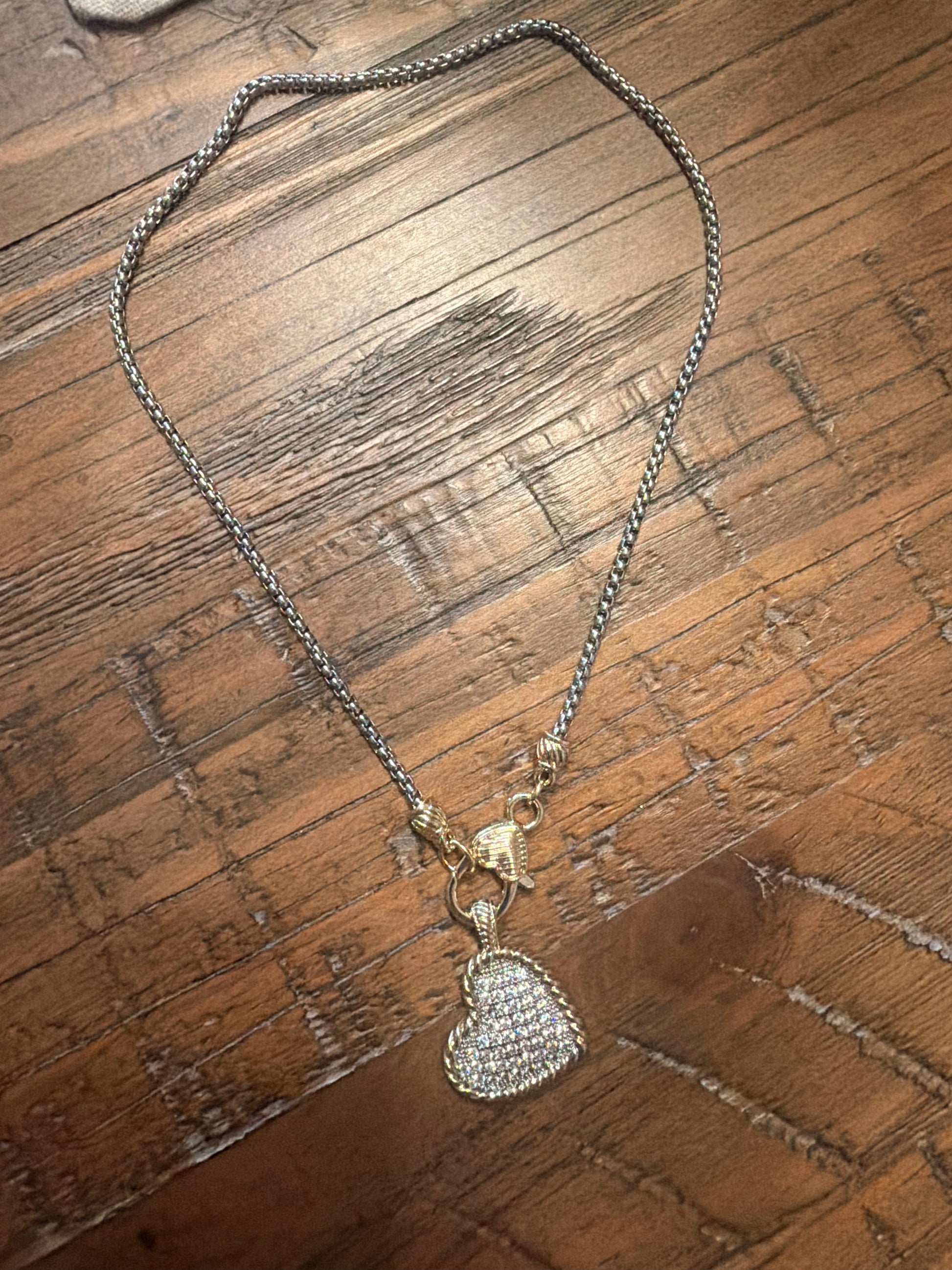     Kimberly Pavé Two-Tone Heart Necklace styled on rustic wood surface