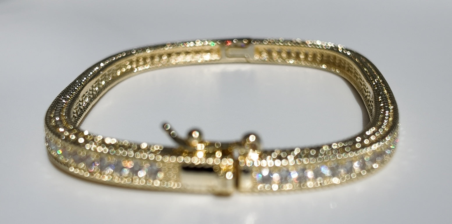     Front view of Monaco gold tennis bangle bracelet with crystal detailing