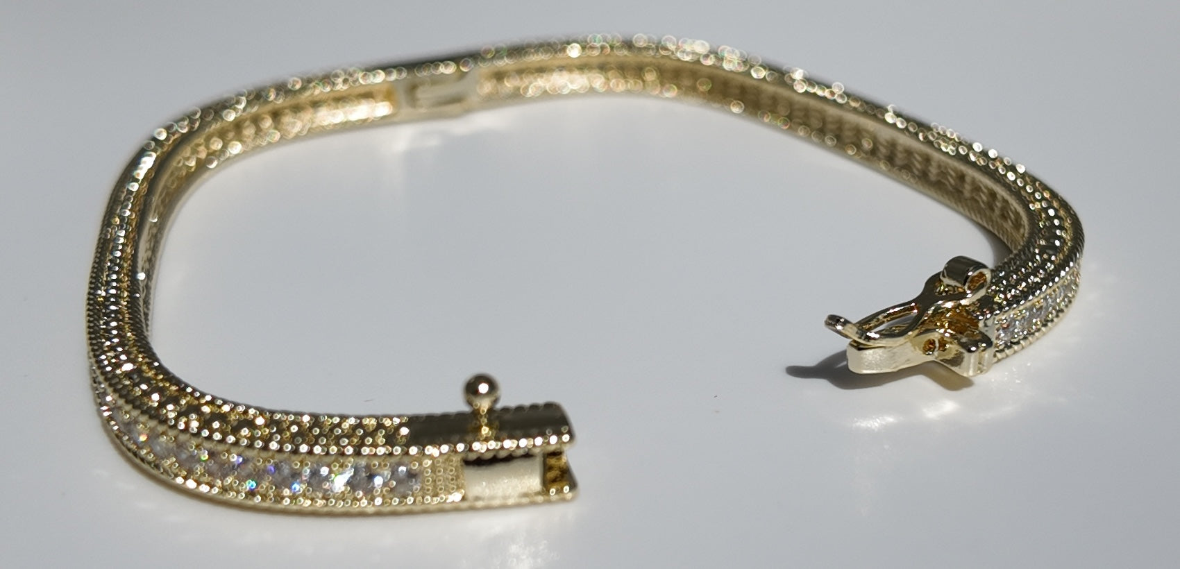     Open clasp detail of Monaco gold cubic zirconia tennis bangle bracelet