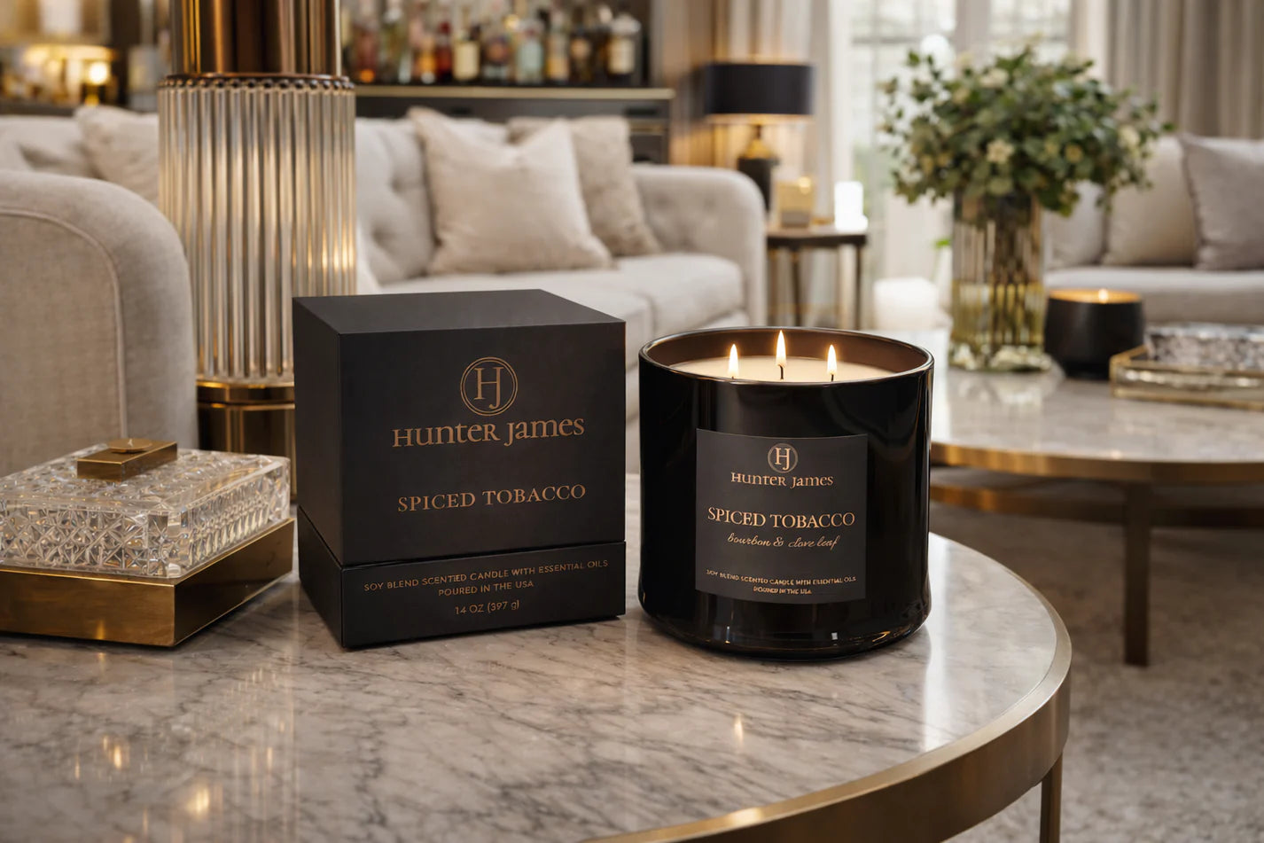Hunter & James spiced tobacco candle and packaging on a marble table in a stylish living room.